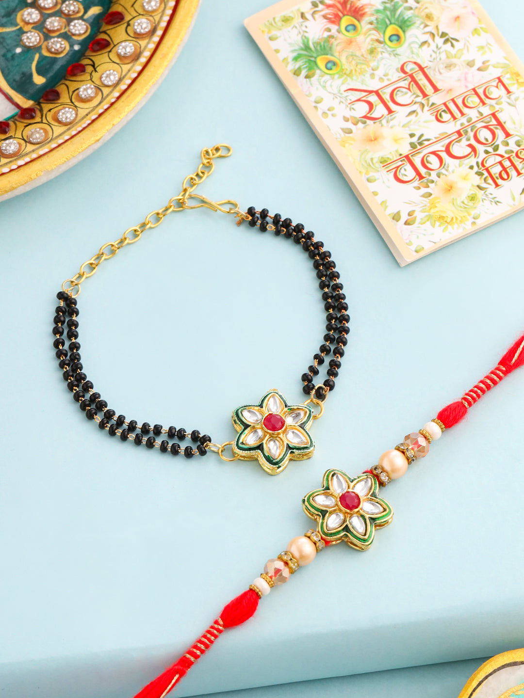 NVR Set of 2 Gold Toned Kundan Studded Floral Shape Bhaiya Bhabhi Rakhi with Roli Chawal Chandan & Mishri | Grocsy