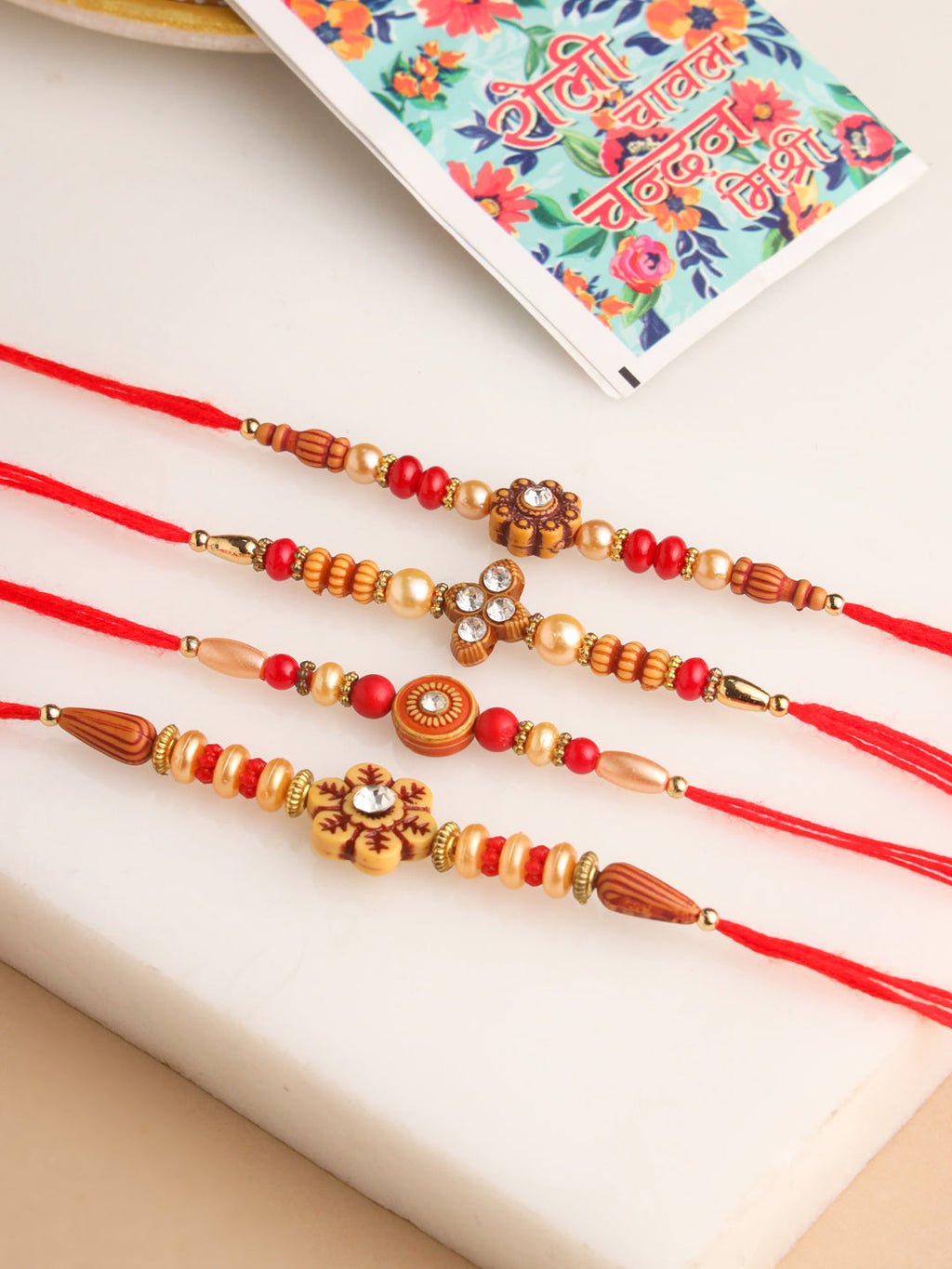 NVR Men Set of 4 Red Artificial Stones & Beads Floral Shape Thread Rakhi with Roli Chawal Chandan & Mishri | Grocsy