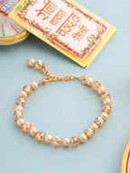 NVR Women Gold Toned Artificial Beads Wraparound Rakhi with Roli Chawal Chandan & Mishri | Grocsy