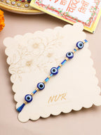 NVR Men's Blue Evil Eye Thread Rakhi with Roli Chawal Chandan & Mishri | Grocsy