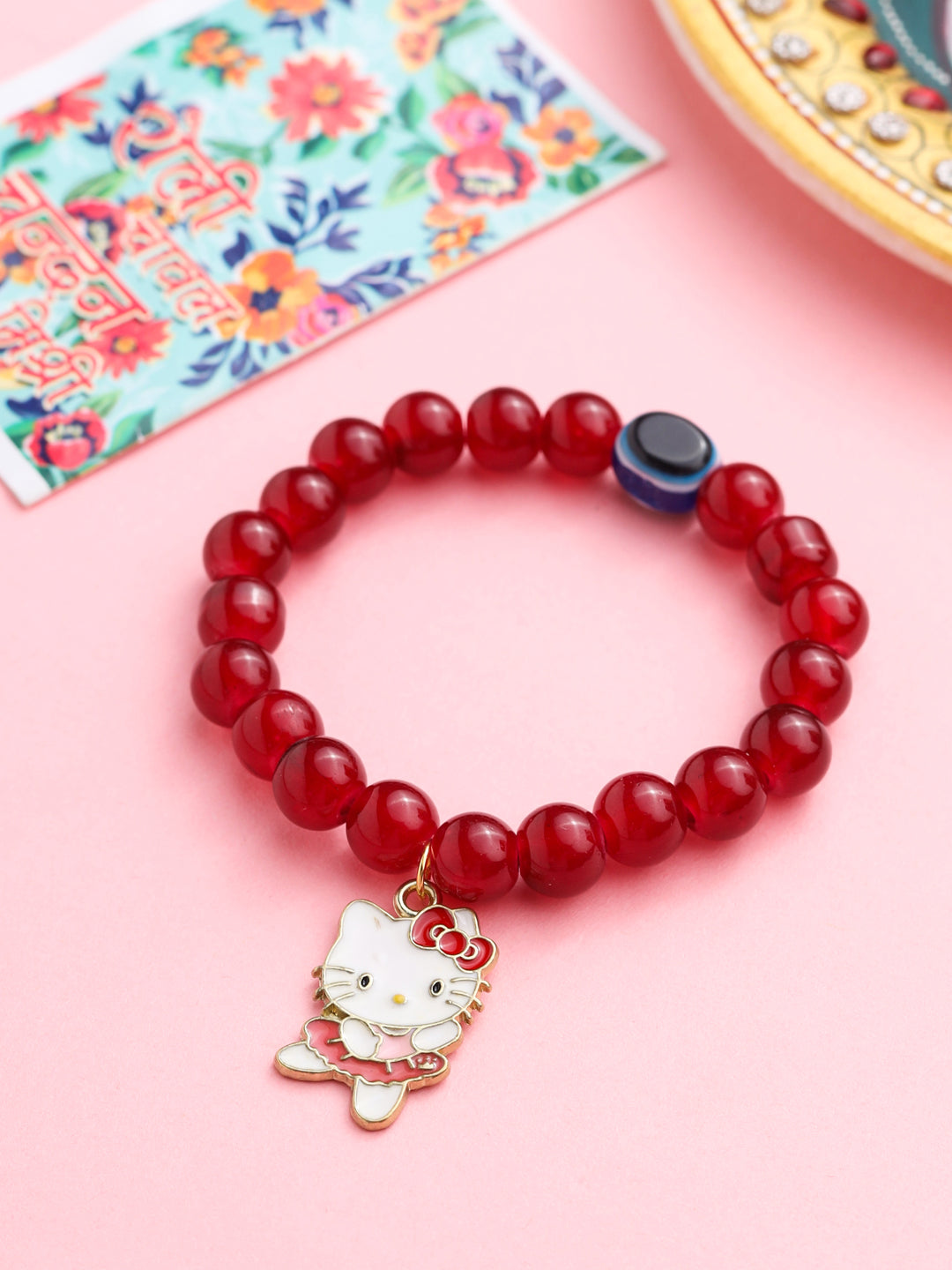 NVR Kids Cartoon Design Maroon Artificial Beads Thread Rakhi with Roli Chawal Chandan & Mishri | Grocsy