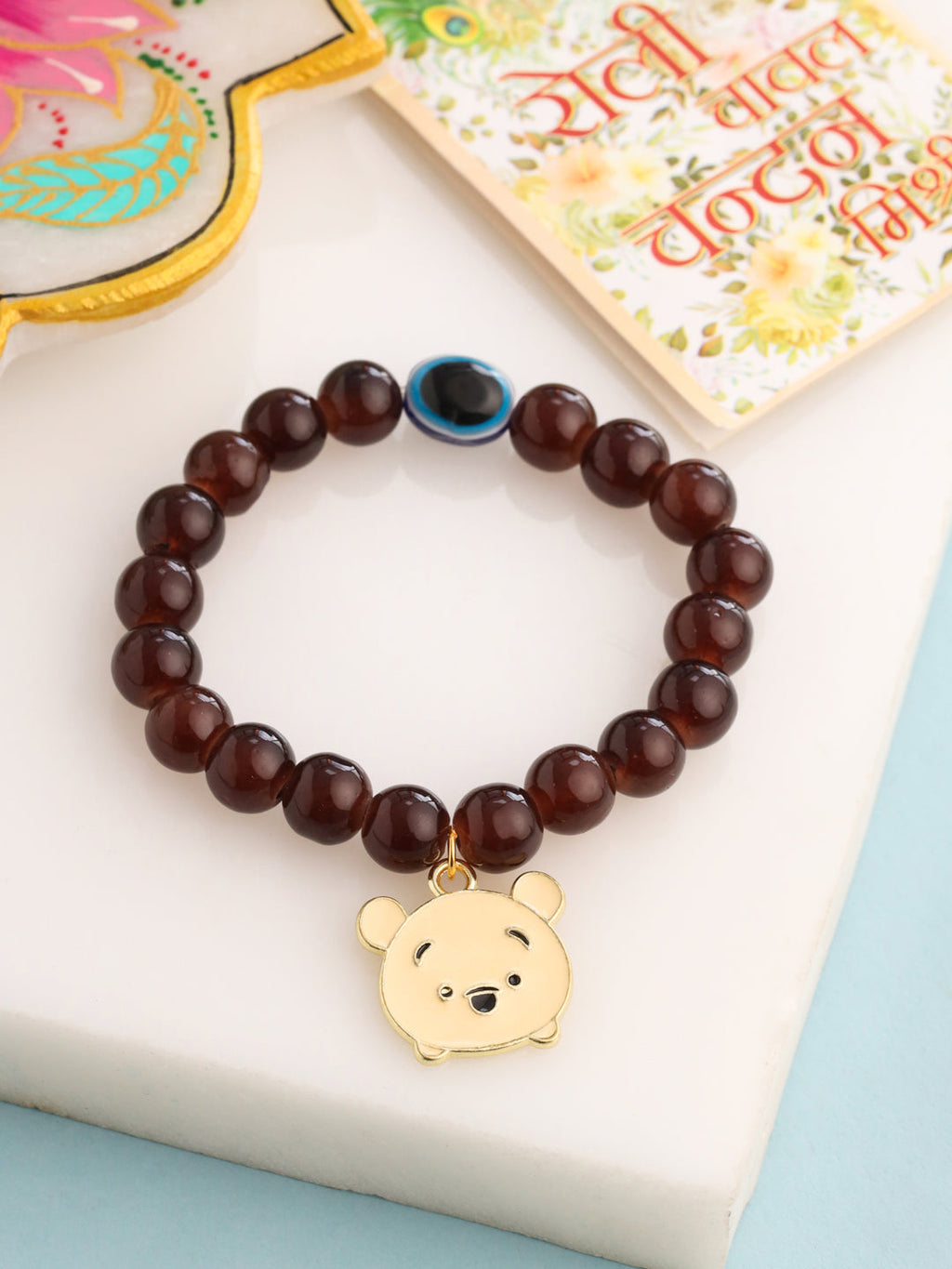 NVR Kids Cartoon Design Brown Artificial Beads Thread Rakhi with Roli Chawal Chandan & Mishri | Grocsy
