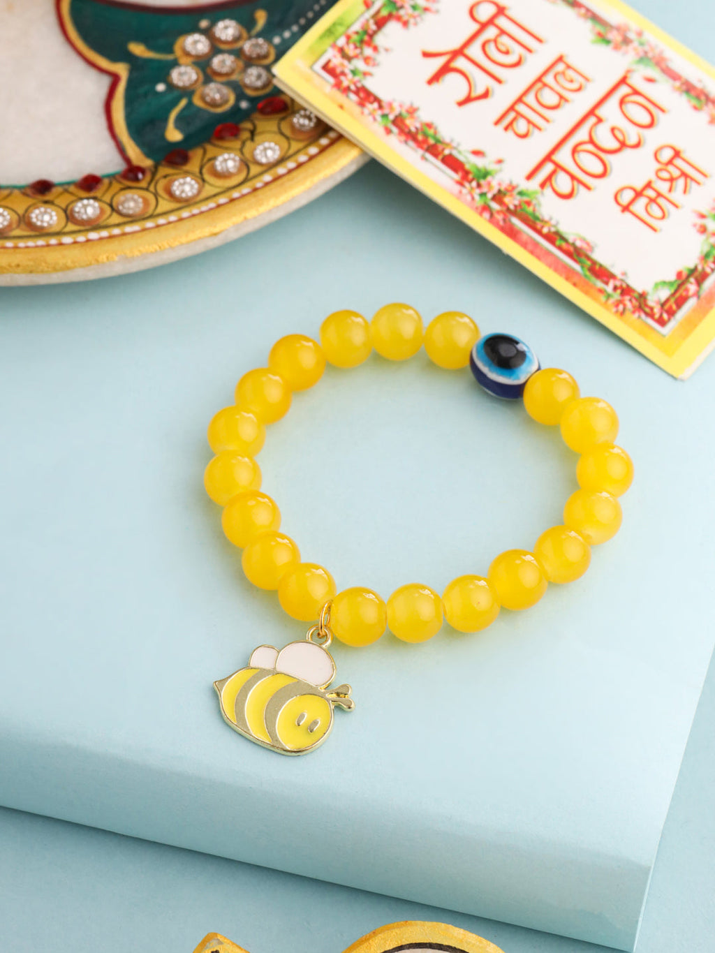 NVR Kids Cartoon Design Yellow Artificial Beads Thread Rakhi with Roli Chawal Chandan & Mishri | Grocsy