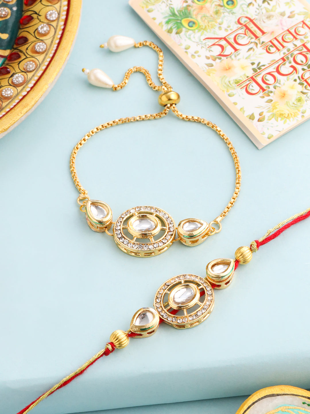 NVR Set of 2 Gold Toned Kundan Studded Bhaiya Bhabhi Rakhi with Roli Chawal Chandan & Mishri | Grocsy