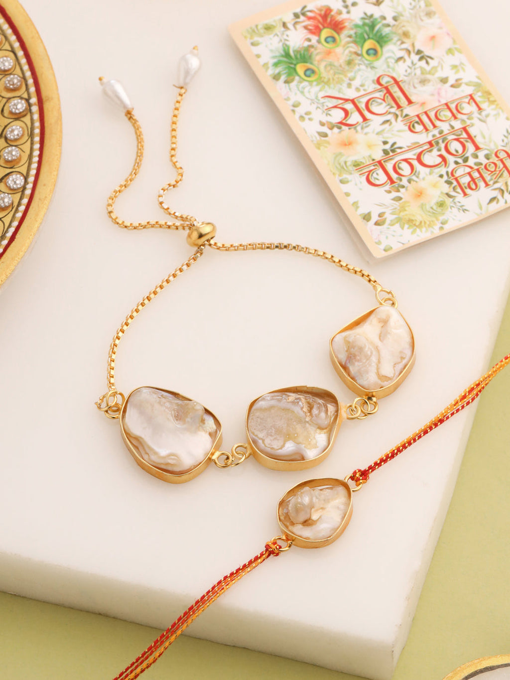 NVR Set of 2 Gold Toned Pearls Bhaiya Bhabhi Rakhi with Roli Chawal Chandan & Mishri | Grocsy