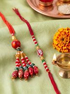 NVR Set of 2 Designer Red Artificial Beads Bhaiya Bhabhi Rakhi with Roli Chawal Chandan | Grocsy