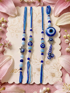 NVR Set of 4 Designer Blue Evil Eye Thread Rakhi with Roli Chawal Chandan Mishri | Grocsy