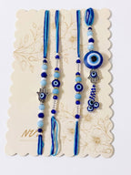 NVR Set of 4 Designer Blue Evil Eye Thread Rakhi with Roli Chawal Chandan Mishri | Grocsy
