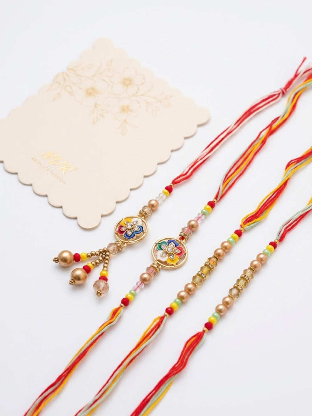 NVR Set of 4 Artificial Beads Family Pack Thread Rakhi with Roli Chawal Chandan Mishri | Grocsy