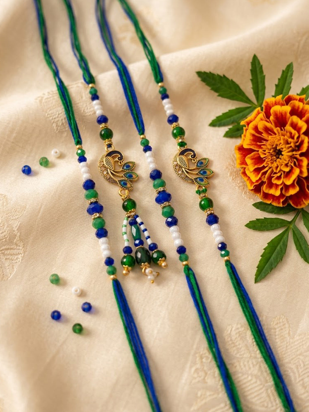 NVR Set of 4 Green Peacock Design Artificial Beads Thread Rakhi with Roli Chawal | Grocsy