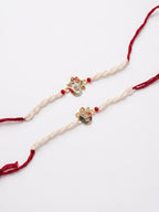 NVR Set of 2 White Pearls Om & Ganesh Ji Thread Rakhi with Roli Chawal Chandan Mishri | Grocsy