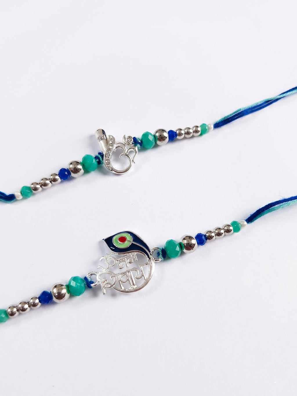 NVR Set of 2 Silver Toned Beaded Religious Thread Rakhi with Roli Chawal Chandan Mishri | Grocsy