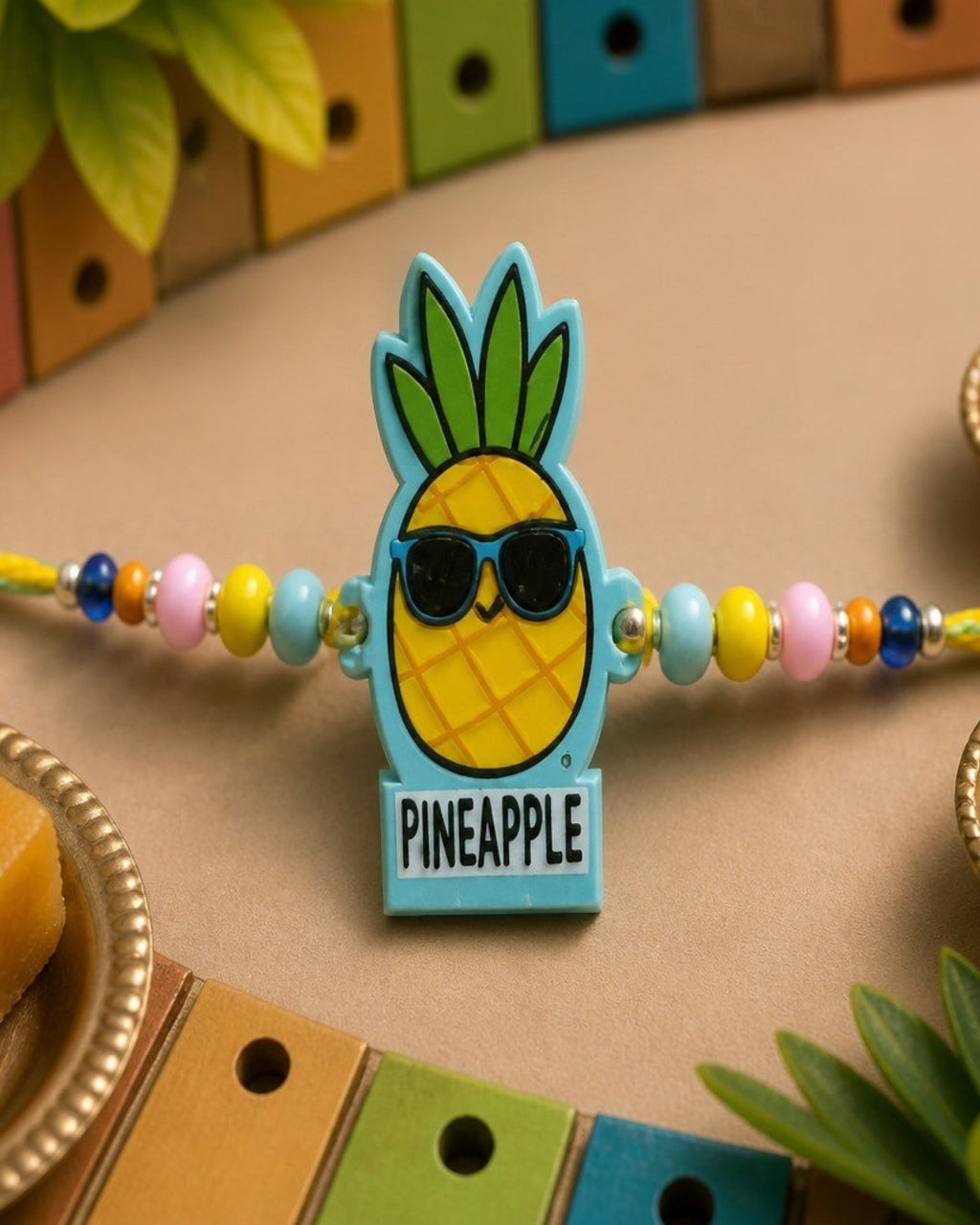 NVR Pineapple Design Kids Thread Rakhi with Roli Chawal Chandan Mishri | Grocsy