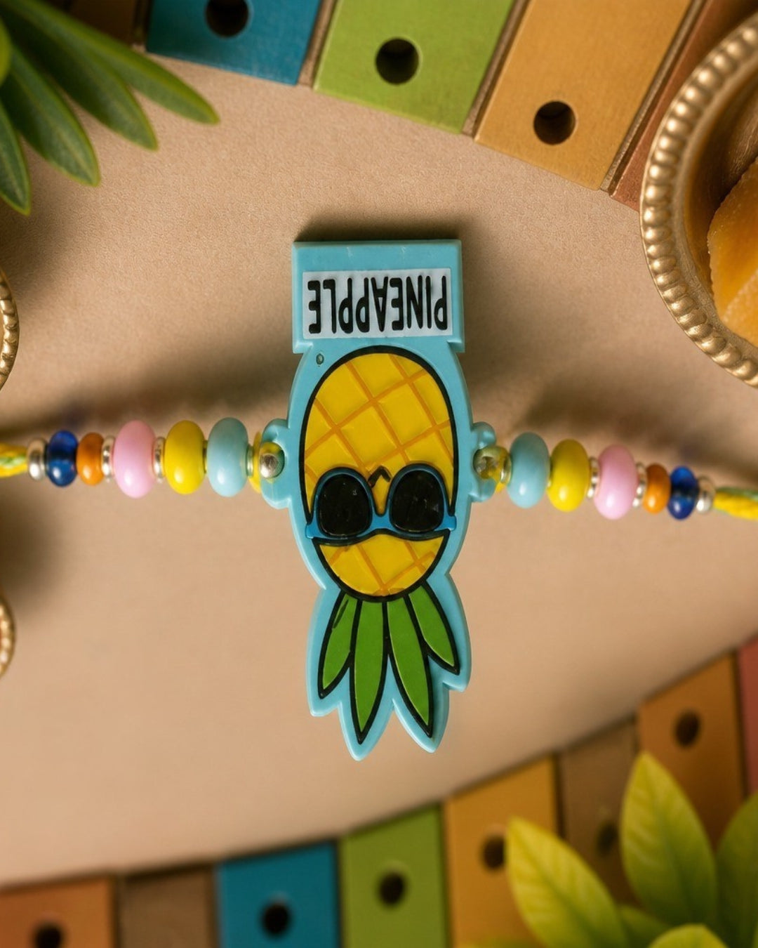 NVR Pineapple Design Kids Thread Rakhi with Roli Chawal Chandan Mishri | Grocsy