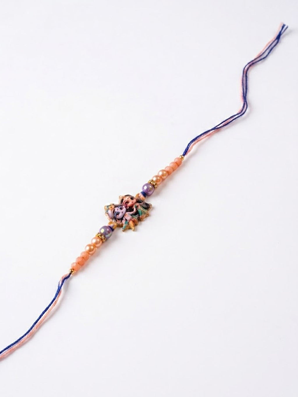 NVR Radha Krishna Multicolor Artificial Beads Thread Rakhi With Roli Chawal Chandan Mishri | Grocsy