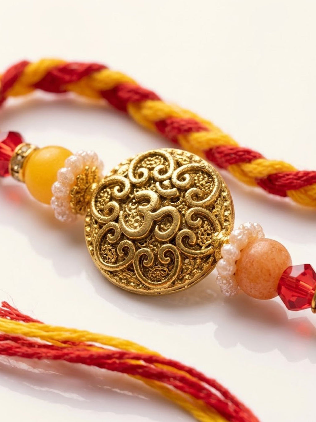 NVR Artificial Beads Decorative Om Design Religious Thread Rakhi with Roli Chawal Chandan | Grocsy