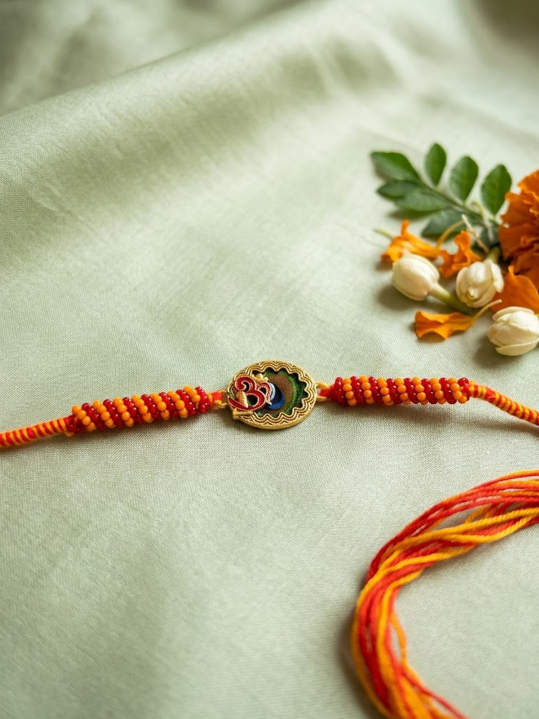 NVR Om Motif Divine Religious Thread Rakhi with Roli Chawal Chandan Mishri | Grocsy