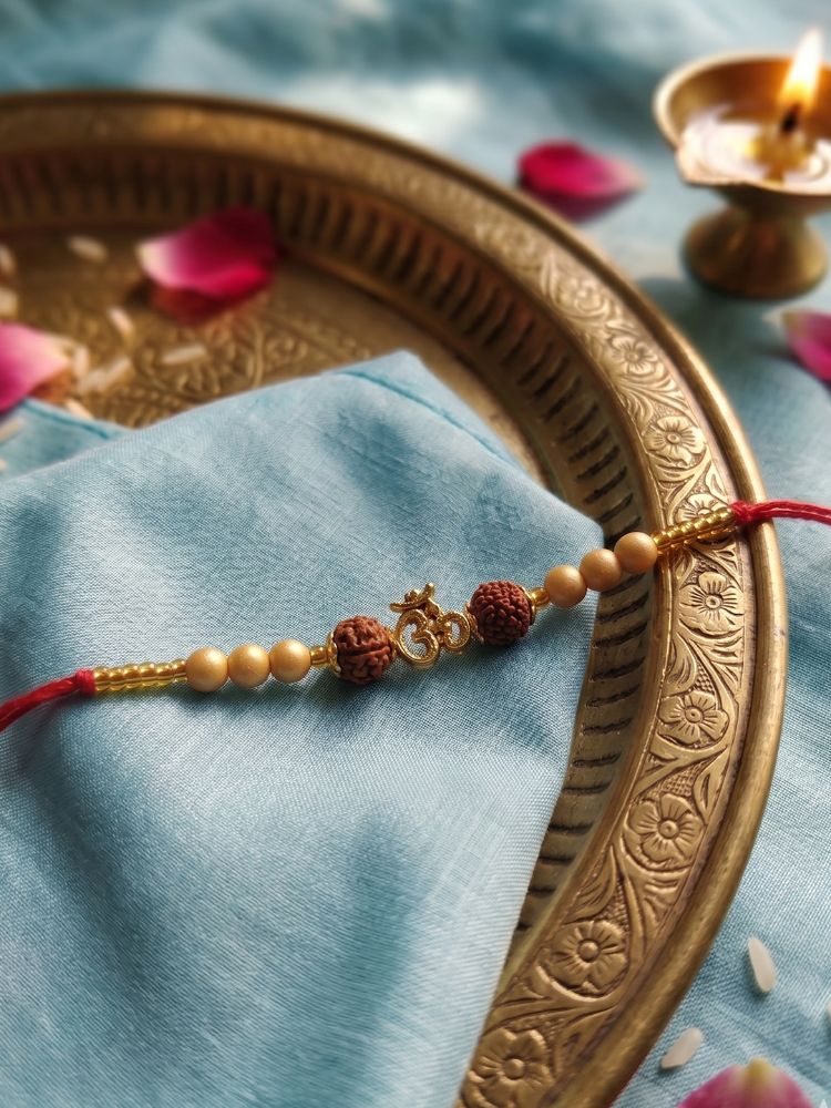 NVR Om Design Rudraksh Thread Rakhi with Roli Chawal Chandan Mishri | Grocsy