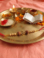 NVR Om Design Rudraksh Thread Rakhi with Roli Chawal Chandan Mishri | Grocsy