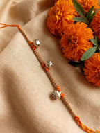 NVR Golden Ghungroo Thread Rakhi with Roli Chawal Chandan Mishri | Grocsy