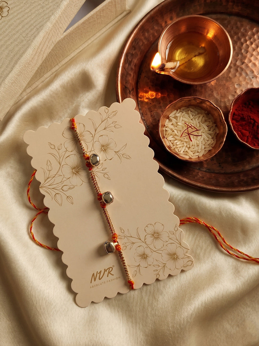 NVR Golden Ghungroo Thread Rakhi with Roli Chawal Chandan Mishri | Grocsy