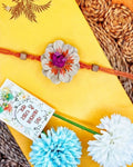 NVR Multicolor Floral Design Plant Seed Rakhi with Roli Chawal Chandan Mishri | Grocsy