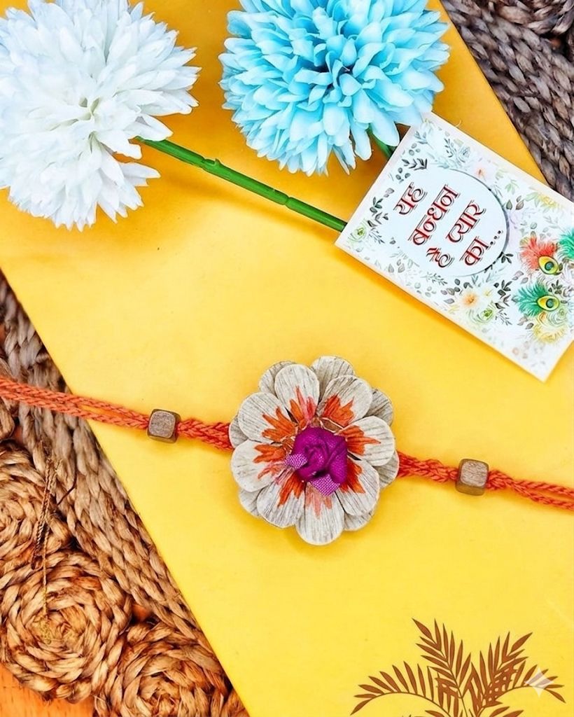 NVR Multicolor Floral Design Plant Seed Rakhi with Roli Chawal Chandan Mishri | Grocsy