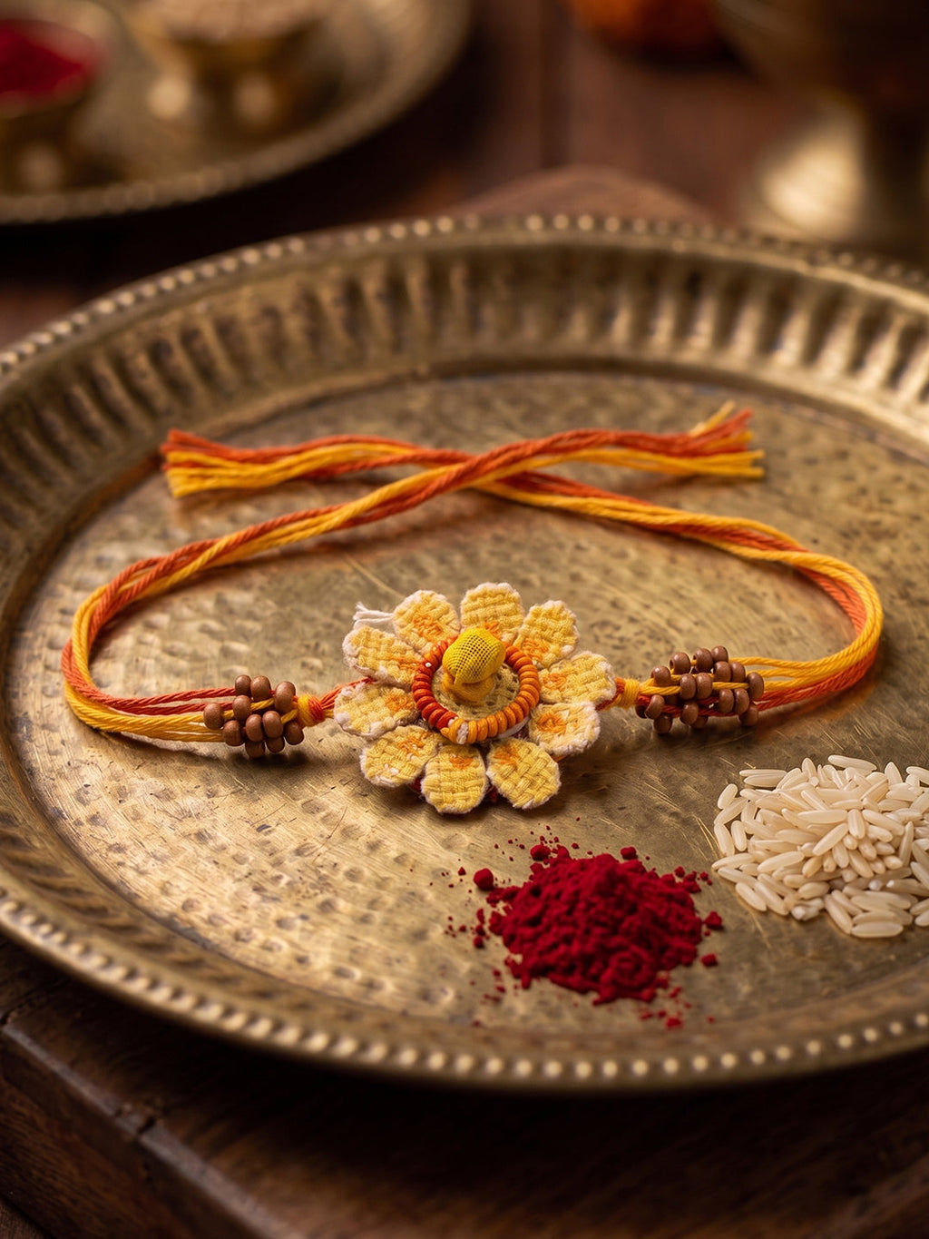 NVR Yellow Floral Seed Thread Rakhi with Roli Chawal Chandan Mishri | Grocsy