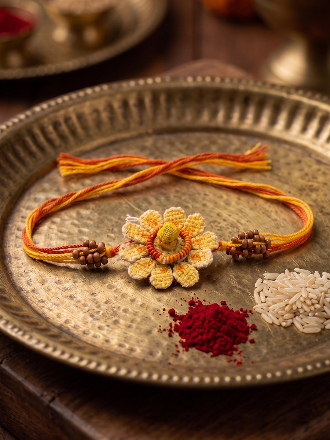 NVR Yellow Floral Seed Thread Rakhi with Roli Chawal Chandan Mishri | Grocsy