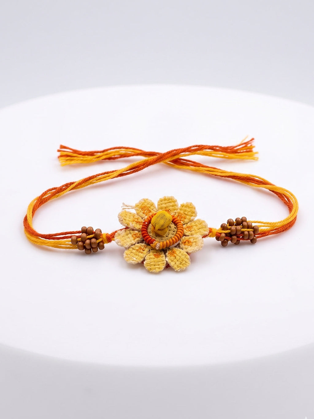 NVR Yellow Floral Seed Thread Rakhi with Roli Chawal Chandan Mishri | Grocsy