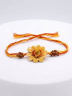 NVR Yellow Floral Seed Thread Rakhi with Roli Chawal Chandan Mishri | Grocsy