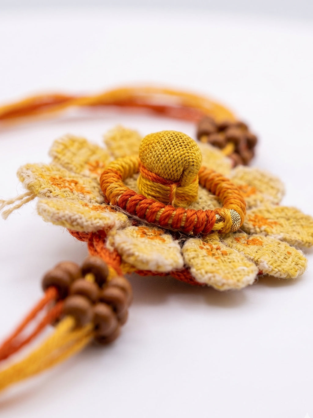 NVR Yellow Floral Seed Thread Rakhi with Roli Chawal Chandan Mishri | Grocsy