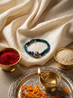 NVR Magnetic Opening Blue Meenakari Work Thread Rakhi with Roli Chawal Chandan Mishri | Grocsy
