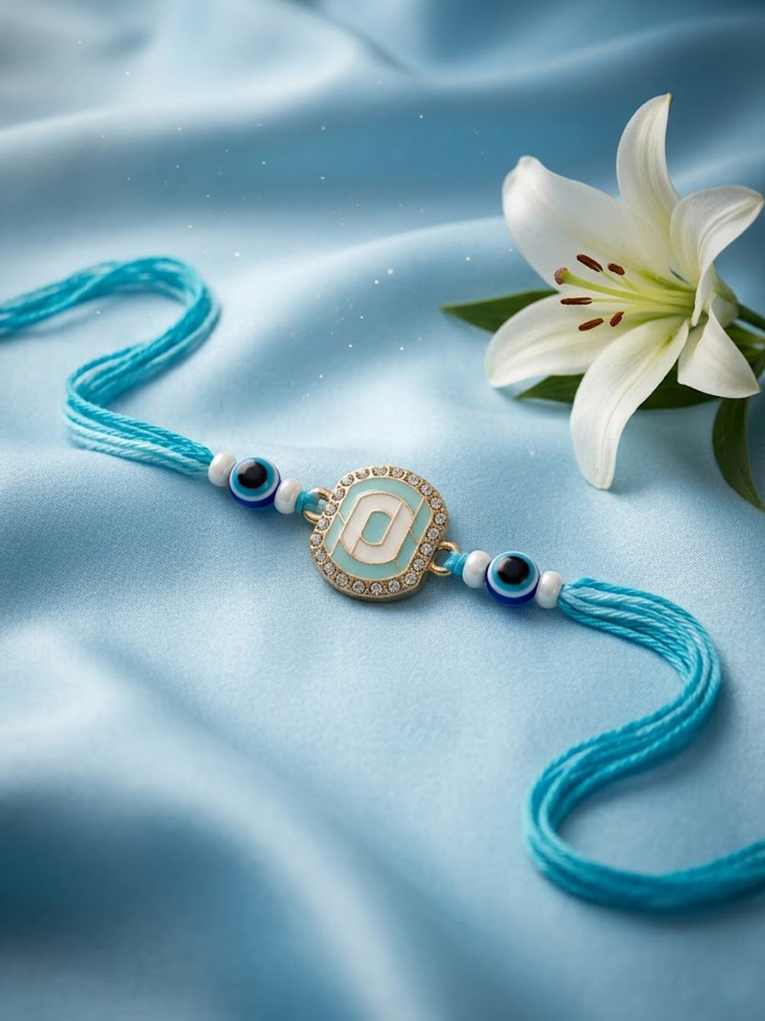 NVR Blue Evil Eye & Artificial Stones Oval Shape Thread Rakhi with Roli Chawal Chandan | Grocsy