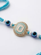 NVR Blue Evil Eye & Artificial Stones Oval Shape Thread Rakhi with Roli Chawal Chandan | Grocsy