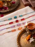 NVR Set of 4 Multicolor Artificial Beads Thread Rakhi with Roli Chawal Chandan Mishri | Grocsy