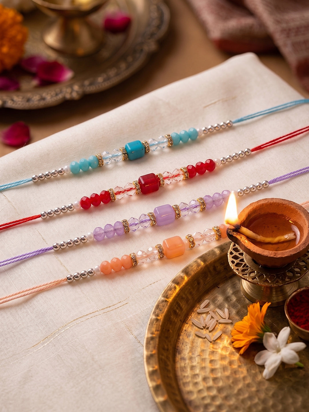 NVR Set of 4 Multicolor Artificial Beads Thread Rakhi with Roli Chawal Chandan Mishri | Grocsy