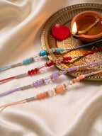 NVR Set of 4 Multicolor Artificial Beads Thread Rakhi with Roli Chawal Chandan Mishri | Grocsy