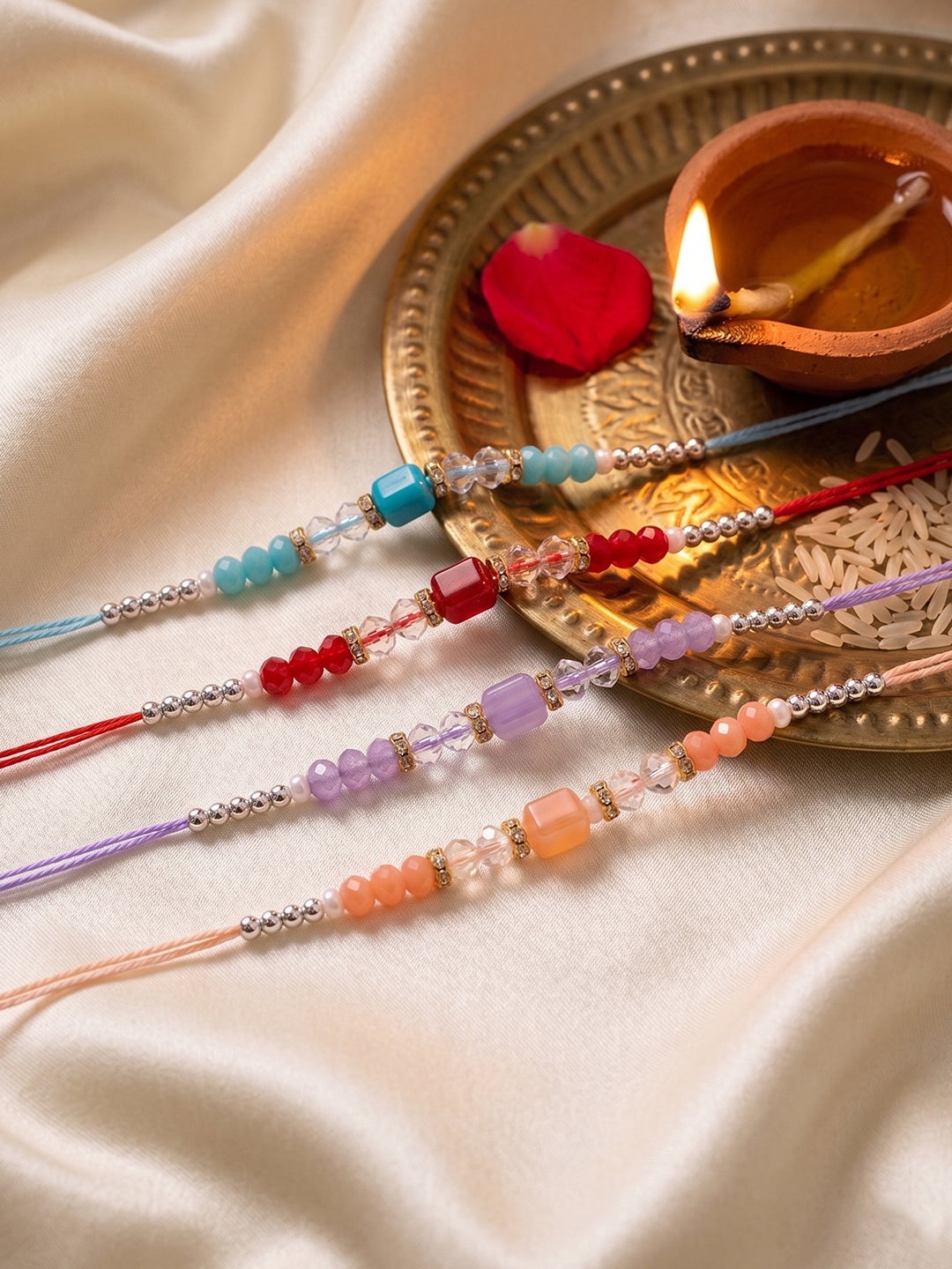 NVR Set of 4 Multicolor Artificial Beads Thread Rakhi with Roli Chawal Chandan Mishri | Grocsy