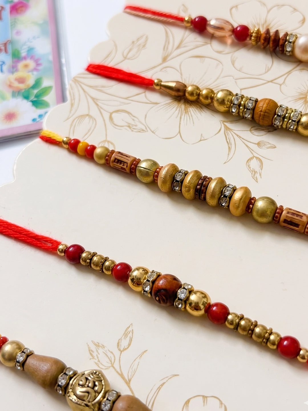 NVR Set of 5 Multicolor Designer Thread Rakhi with Roli Chawal Chandan Mishri | Grocsy