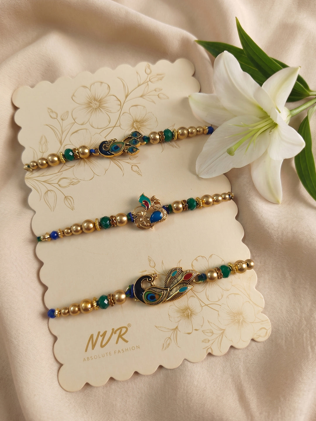 NVR Set of 3 Peacock Design Multicolor Artificial Beads Thread Rakhi With Roli Chawal | Grocsy