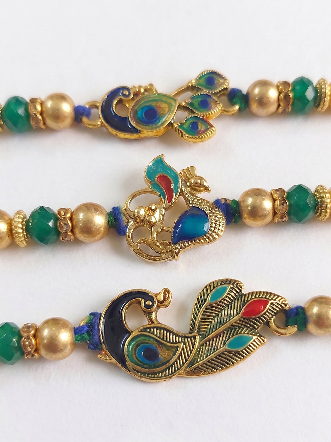 NVR Set of 3 Peacock Design Multicolor Artificial Beads Thread Rakhi With Roli Chawal | Grocsy