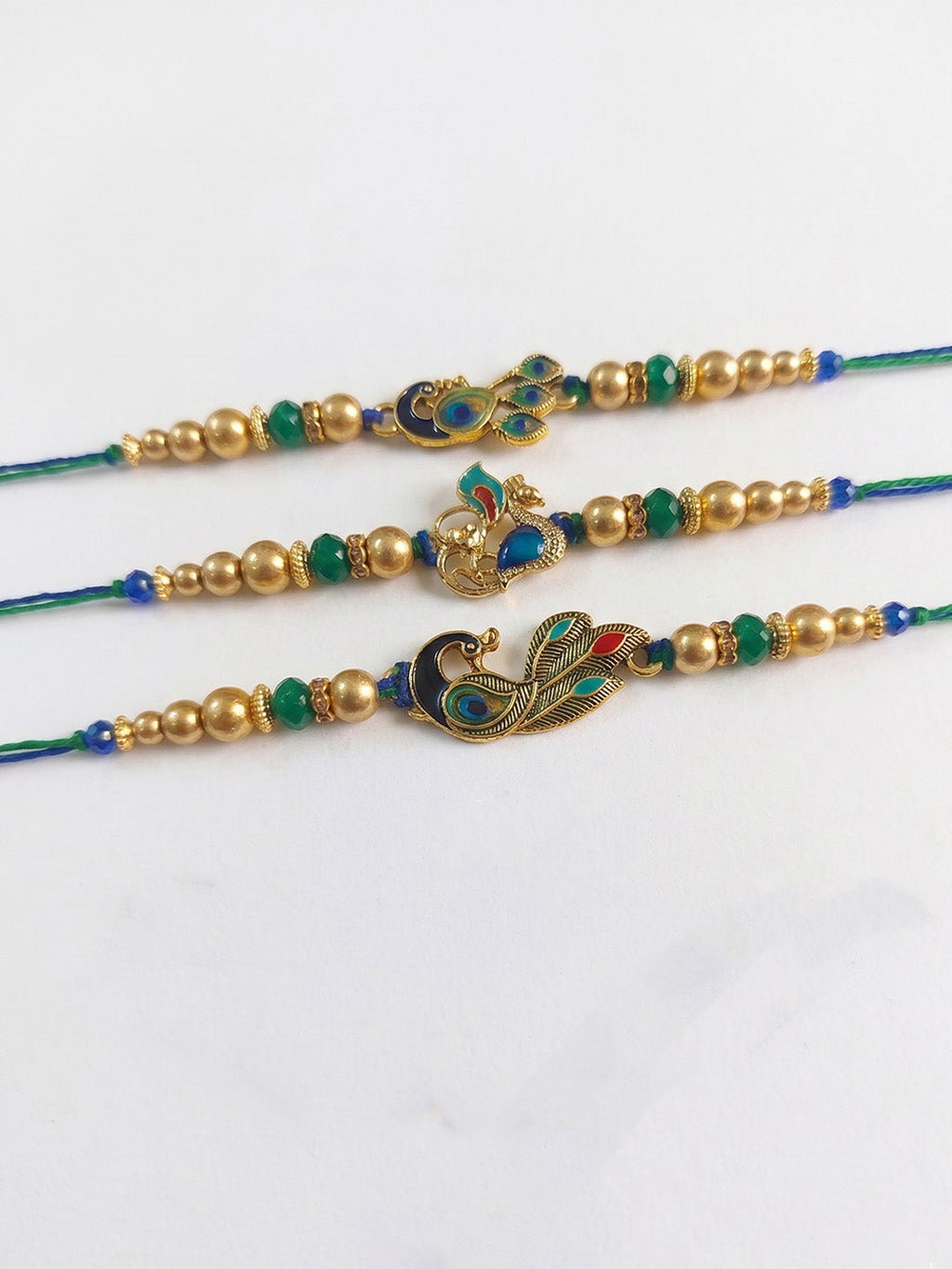 NVR Set of 3 Peacock Design Multicolor Artificial Beads Thread Rakhi With Roli Chawal | Grocsy
