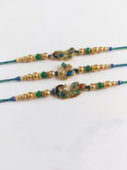 NVR Set of 3 Peacock Design Multicolor Artificial Beads Thread Rakhi With Roli Chawal | Grocsy