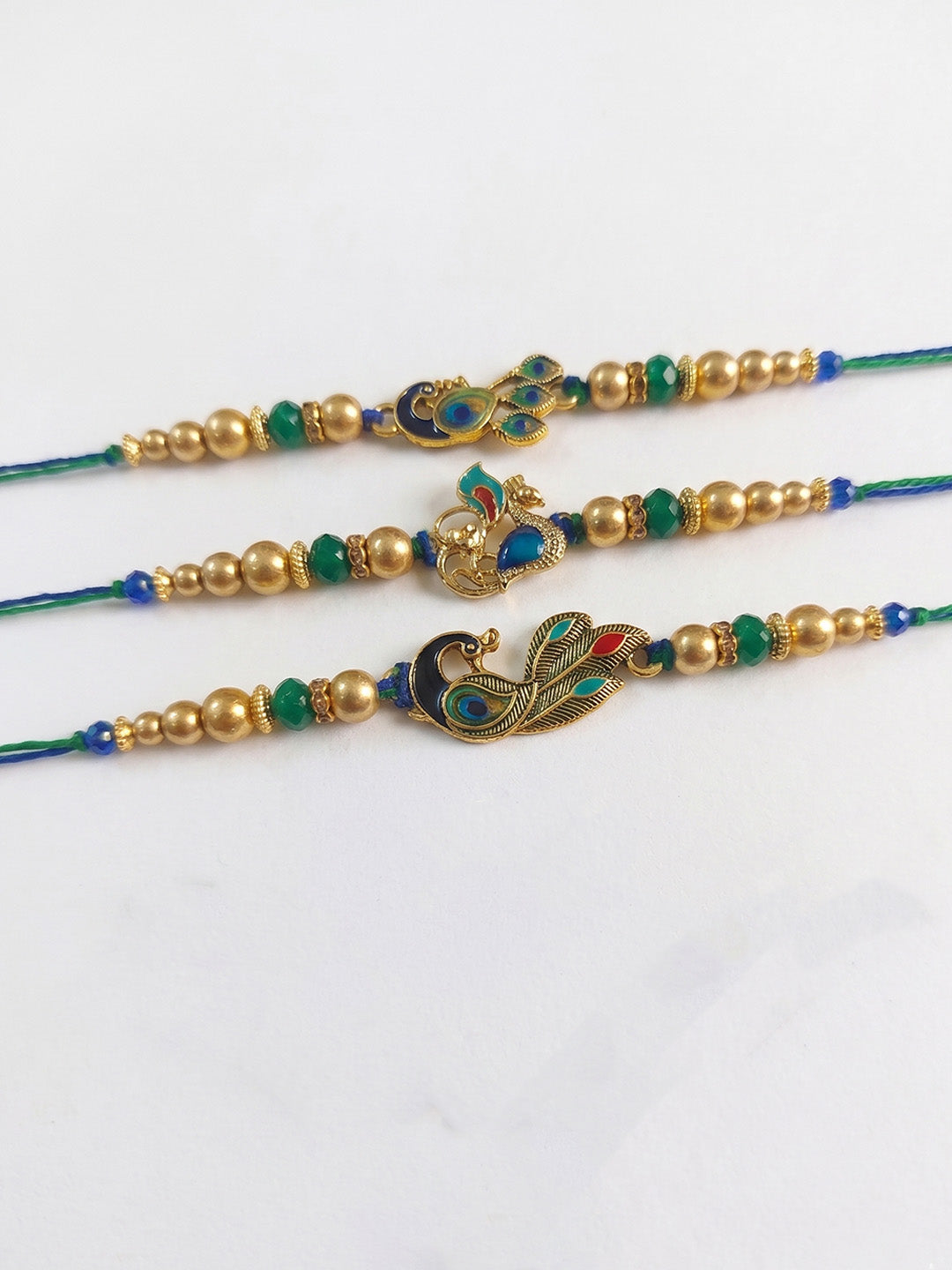 NVR Set of 3 Peacock Design Multicolor Artificial Beads Thread Rakhi With Roli Chawal | Grocsy
