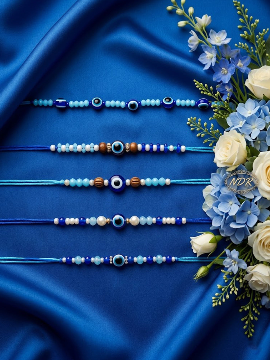 NVR Set of 5 Blue Evil Eye Thread Rakhi with Roli Chawal Chandan Mishri | Grocsy