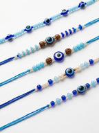 NVR Set of 5 Blue Evil Eye Thread Rakhi with Roli Chawal Chandan Mishri | Grocsy