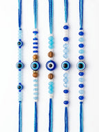 NVR Set of 5 Blue Evil Eye Thread Rakhi with Roli Chawal Chandan Mishri | Grocsy