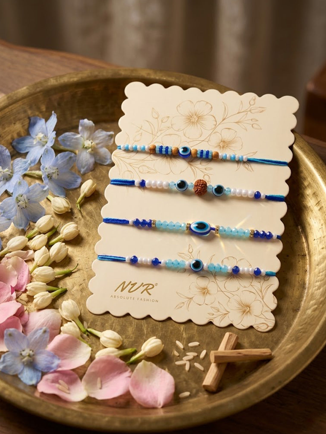 NVR Set of 4 Blue Evil Eye Thread Rakhi with Roli Chawal Chandan Mishri | Grocsy