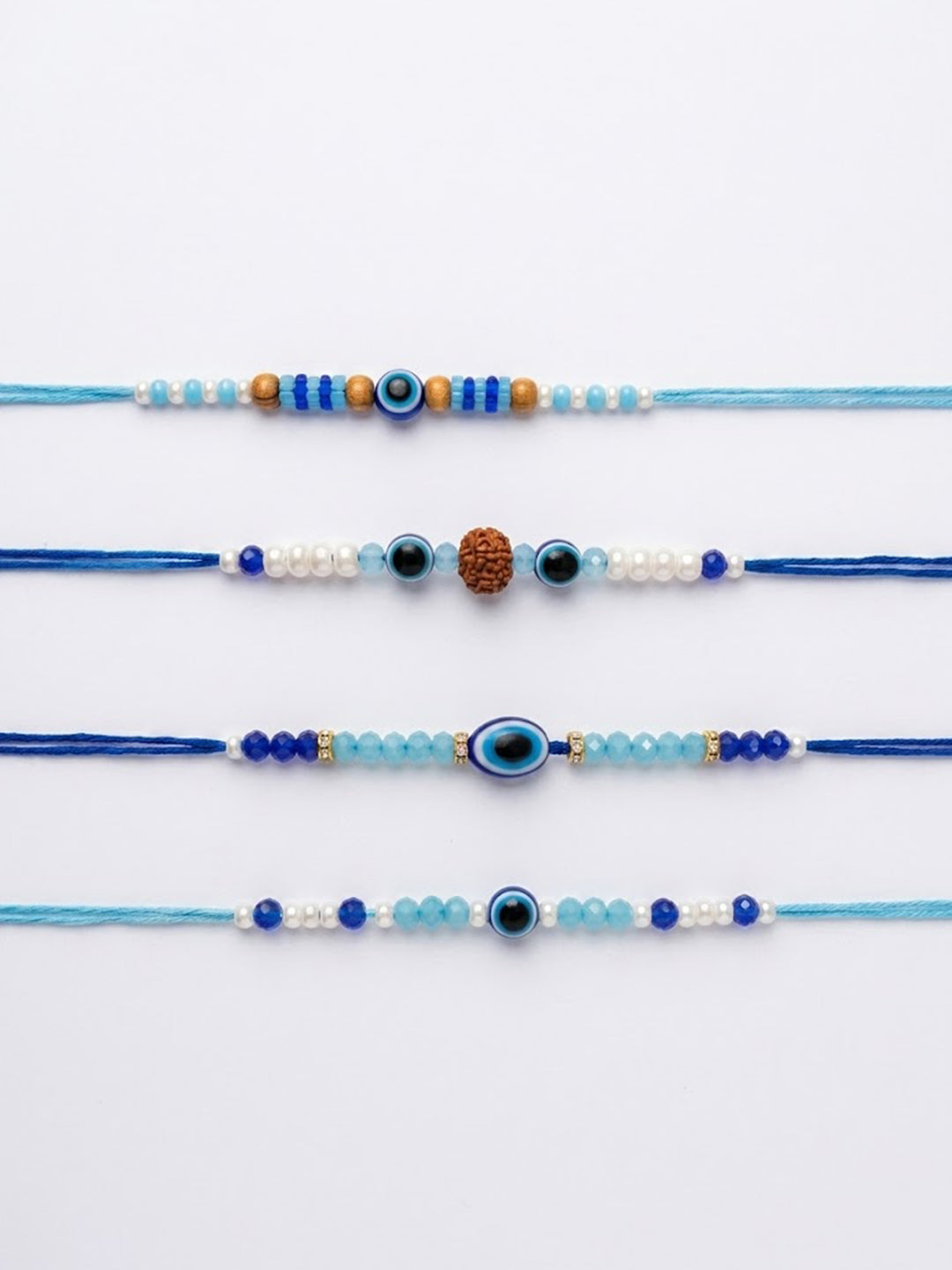 NVR Set of 4 Blue Evil Eye Thread Rakhi with Roli Chawal Chandan Mishri | Grocsy